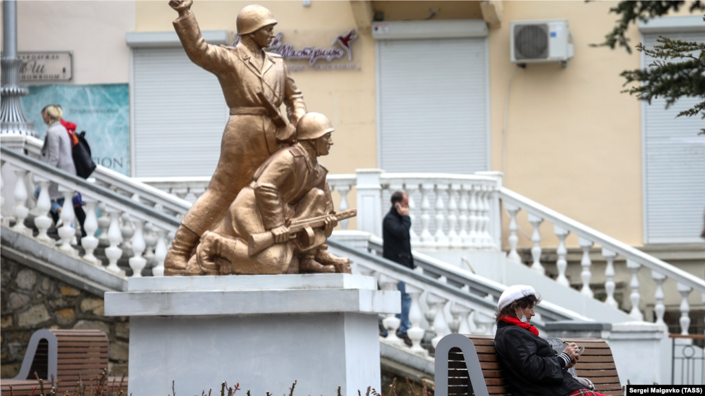 Отдыхающие и прохожие в сквере у кинотеатра «Победа» в Севастополе