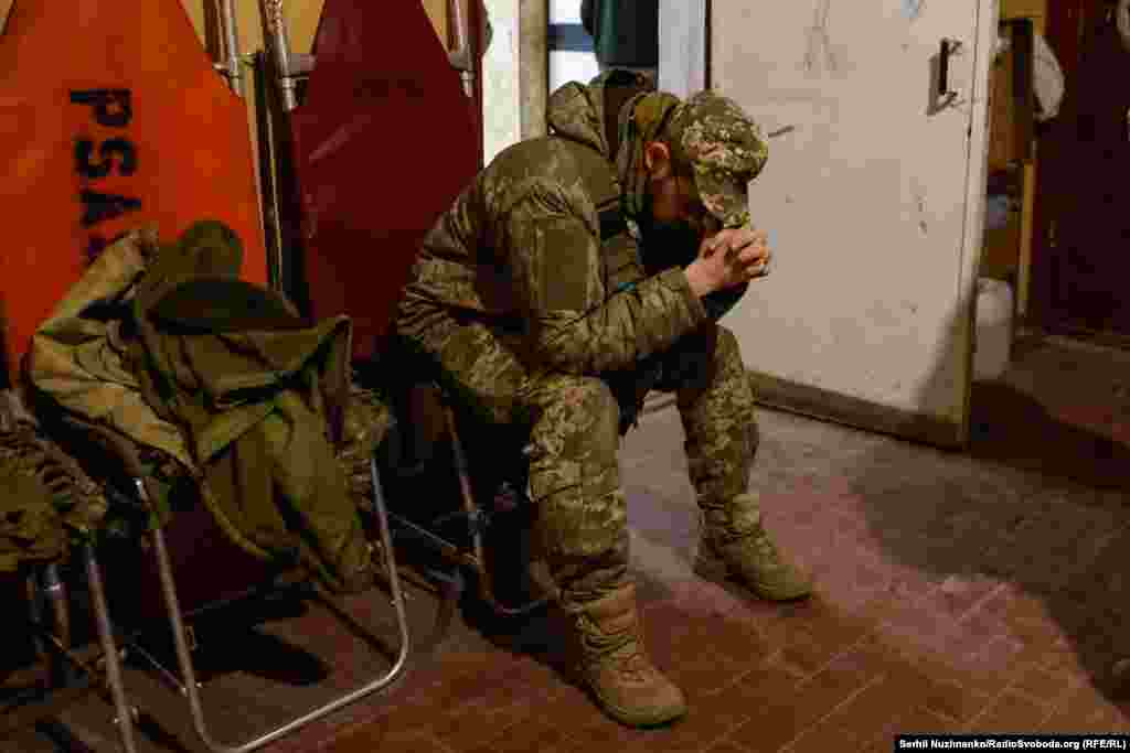 За ширмою медики рятують життя українському військовому. А по інший бік завіси, побратим пораненого в очікуванні вердикту медиків. Стабпункт, Авдіївський напрямок, березень 2024 року