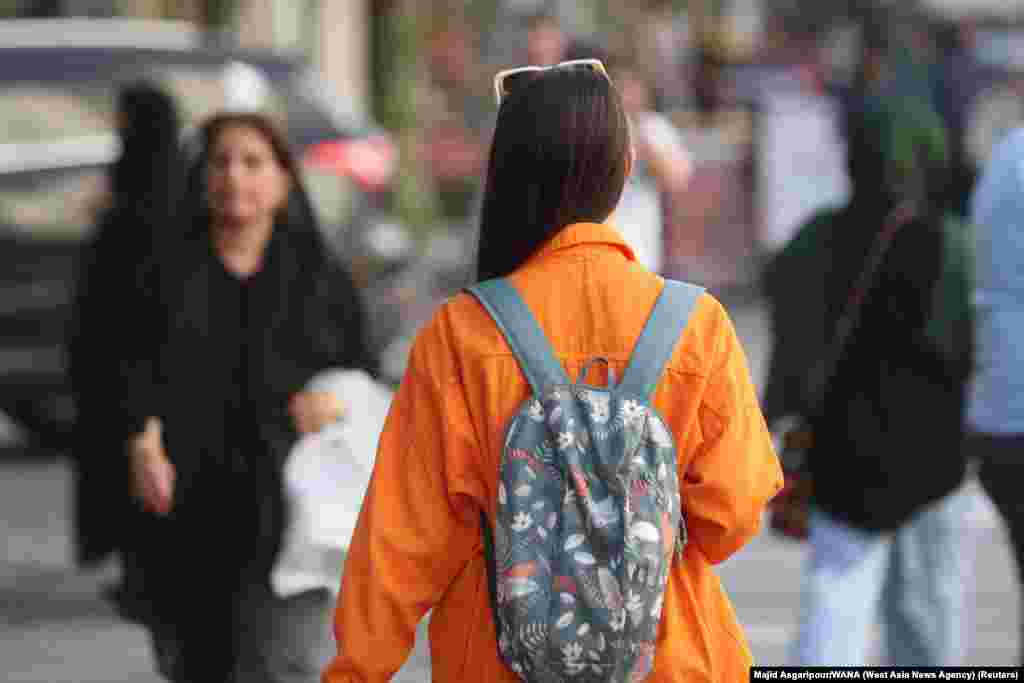 A woman goes without the mandatory hijab in Tehran on July 16. An Iranian official on July 16 confirmed that patrols of the notorious morality police, known officially as Guidance Patrols, have returned to Iran’s streets after months of keeping a low profile. The patrols enforce laws around clothing and behavior between the sexes.  