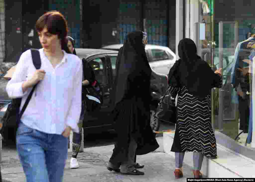 Contrasting clothing styles seen in Tehran on July 16.  Shortly after the July 16 announcement that the morality police would return to on-the-spot enforcement, clashes broke out in the northern city of Rasht after they attempted to arrest three women. 