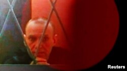 Russian opposition leader Aleksei Navalny appears on a screen from prison during a hearing in Moscow on January 11.