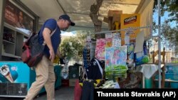 Muškarac polaže cvijeće na mjesto gdje je 29-godišnji grčki navijač poginuo nakon noćnih sukoba rivalskih navijača u predgrađu Nea Filadelfije, u Atini, Grčka, u utorak, 8. kolovoza 2023.