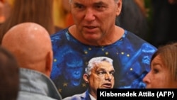 A Fidesz party supporter wears a T-shirt with a portrait of Hungarian Prime Minister Viktor Orban during the EU elections in Budapest on June 9.
