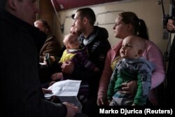 Ірина Григор'єва сидить зі своїм сином Богданом в евакуаційному поїзді на вокзалі в Покровську. Донецька область, 13 лютого 2023 року