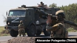Фото російського інформагенства ТАСС. Російські військовослужбовці супроводжують переміщення військової колонни на окупованій території Запорізької області України 