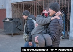 Ігор Чорний під час евакуації виносить жінку на руках