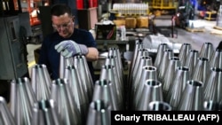An employee handles 155 mm caliber shells after the manufacturing process at the Scranton Army Ammunition Plant (SCAAP) in Scranton, Pennsylvania on April 16, 2024