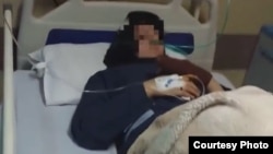 A female student of a school in the city of Qom is seen in a hospital after feeling sick.