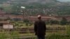 Zenica, Bosnia and Herzegovina -- An activist looking at pollution made by a steel plant from a hill