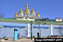 Тисячі імен і фотографій тих, хто загинув, стримуючи агресію Росії. Стіна пам'яті полеглих захисників України в російсько-українській війні. Київ, 14 березня 2023 року