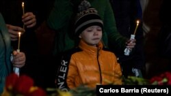 Хлопчик плаче на похоронах своїх брата і сестри, які загинули 28 квітня внаслідок російського ракетного удару по багатоповерхівці в Умані. Фото від 30 квітня 2023 року