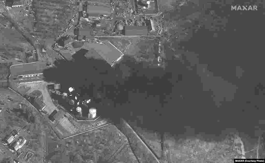 Баки для зберігання палива та військова техніка, розгорнута навколо аеропорту «Антонова», у вогні. Satellite image ©2022 Maxar Technologies