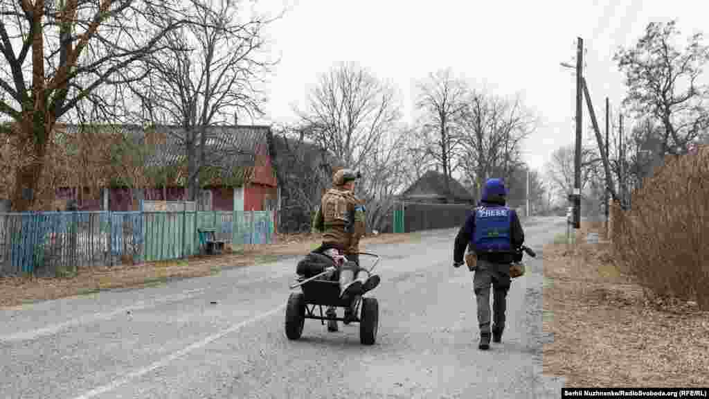 Український військовий  і журналісти евакуйовують останнього жителя 