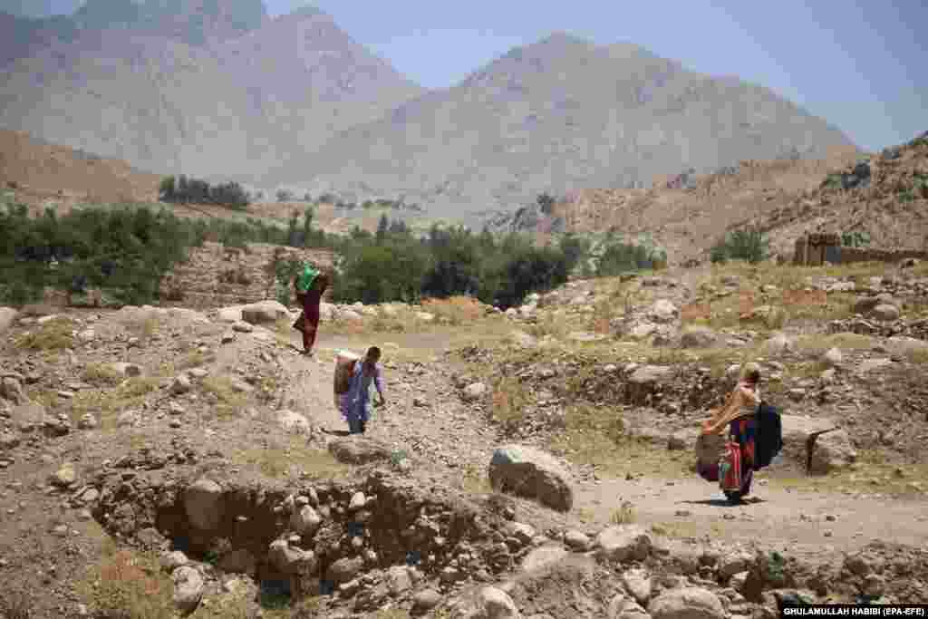 Civilians flee from the Alishang district of Laghman Province as Afghan security forces battled the Taliban on July 8.