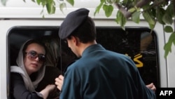 An officer from Iran's morality police speaks with a woman about her hijab in Tehran. (file photo)
