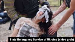 First responders help a victim of a Russian glide bomb strike in Kharkiv that followed an especially massive and destructive overnight drone attack against the city on June 7.