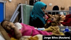 Farzana, 30, holds her 1-year-old son, Omar, at the malnutrition ward for infants at Indira Gandhi Children's Hospital in Kabul on October 23.