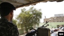 An Iraqi policeman mans a machine gun at a checkpoint in Baghdad.