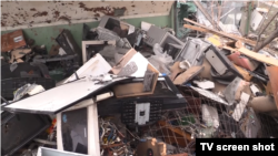 Купа уламків побутової техніки, яку зносили в двір однієї з адміністративних будівель Бородянки російські військові