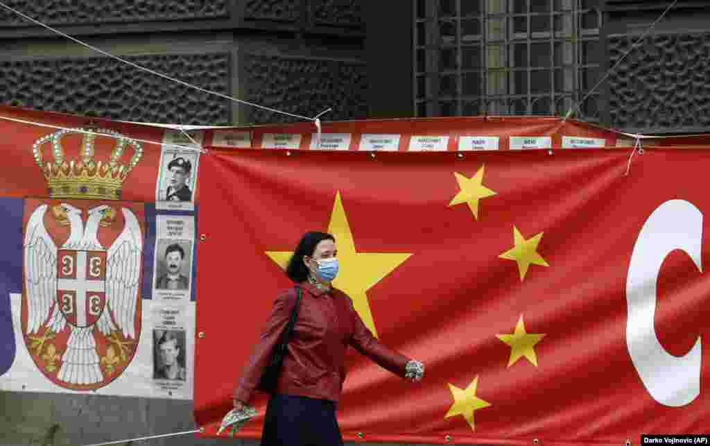 A woman walks past giant banners linking Chinese and Serbian flags in Belgrade.   Zoric says both China and Russia are “very present” in Serbia and such signage may be a way of hinting to the EU that the country has options for geopolitical alignment. “I think Serbia is trying to make the EU jealous a little bit. Otherwise, we could open ourselves to Russia and China.”