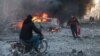 People try to extinguish fires following an air strike that targeted Syria's rebel-held northern city of Idlib on December 2. Since Russia intervened in the civil war in Syria, its aerial attacks have played a crucial role in propping up Syrian President Bashar al-Assad.