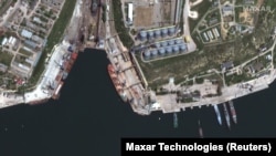 На супутниковому знімку видно балкер, на який завантажують зерно в порту Севастополя, 21 травня 2022 року