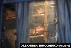 Поранені українські воїни в автобусі після виходу з «Азовсталі». Автобус під конвоєм російських військових їде до окупованого Новоазовська.16 травня 2022 року