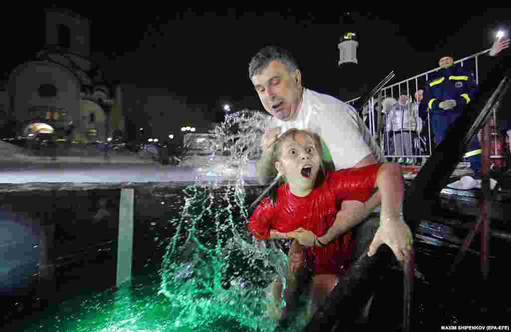 A young girl reacts to the icy waters in Krasnogorsk, near Moscow. 