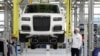 An employee checks an Aurus Senat car on an assembly line at a manufacturing plant in the town of Yelabuga in Russia's Tatarstan region.