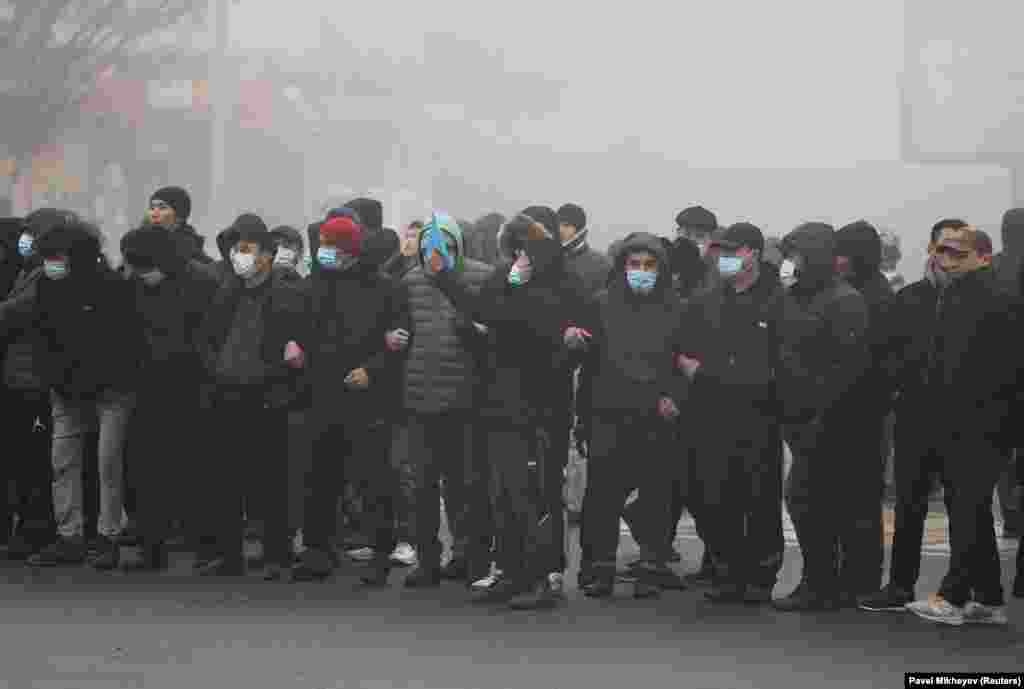 Demonstrators link arms in Almaty on January 5. 