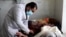 A doctor treats a COVID-19 patient at a hospital in Khost, southeastern Afghanistan.