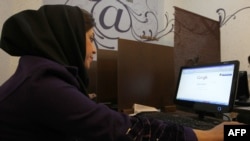 A woman surfs the Internet at a cybercafe in central Tehran. (file photo)
