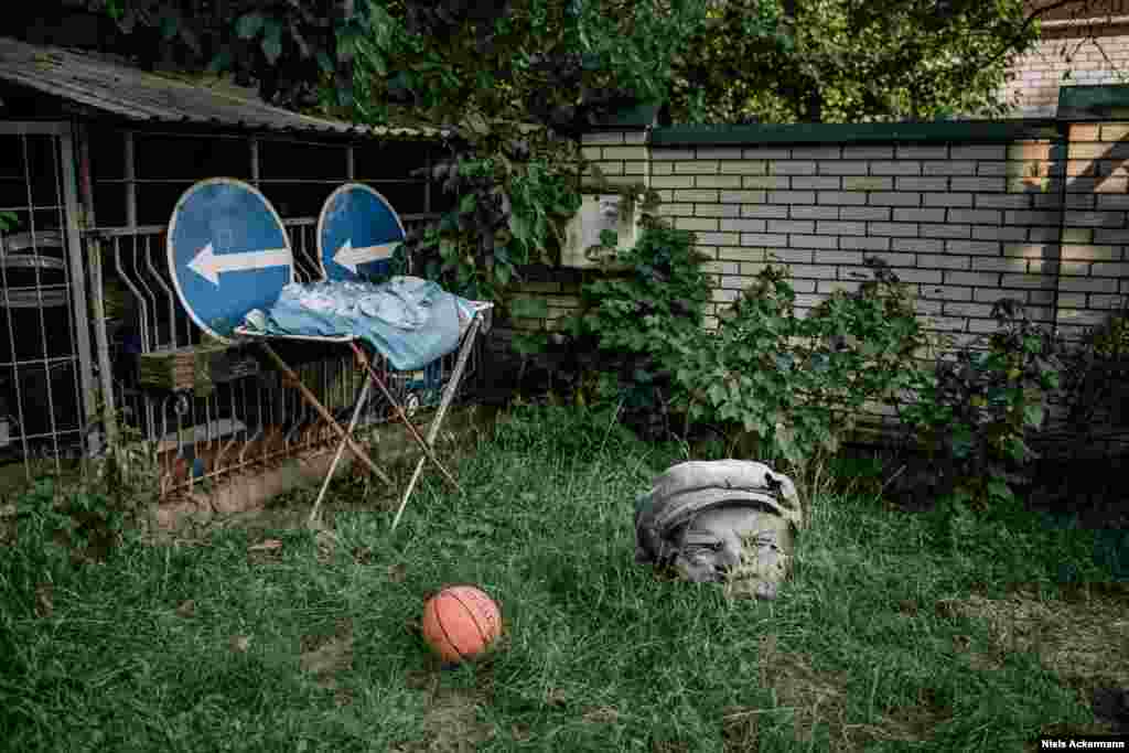 A Lenin head sits in the Kyiv garden of a volunteer who assisted the Ukrainian Army in fighting Russia-backed separatists. It was a birthday present from a group of soldiers she had helped.    