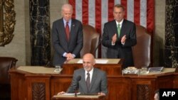 Afghan President Ashraf Ghani (center) is applauded by House Speaker John Boehner (right) and Vice President Joe Biden (left) as he arrives to addresses a joint session of Congress at the U.S. Capitol in Washington in 2015.