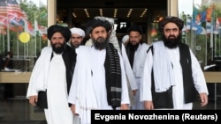 Members of a Taliban delegation, led by chief negotiator Mullah Abdul Ghani Baradar (center), leave after peace talks with Afghan politicians in Moscow in May.