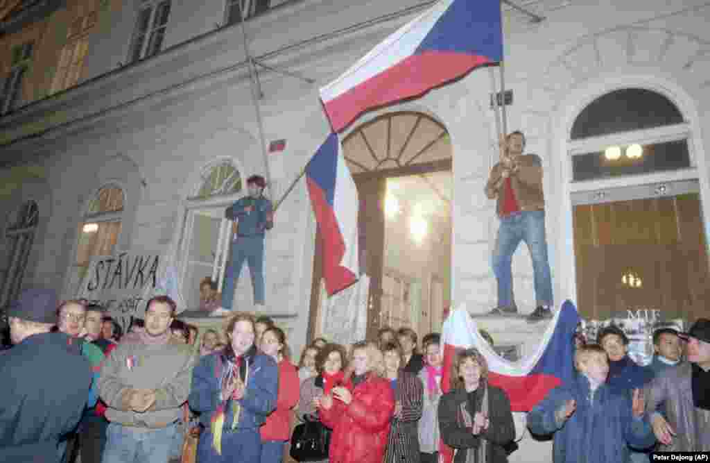 Protesters wave Czechoslovak flags in front of the national film school as students and theater actors declared a strike.   