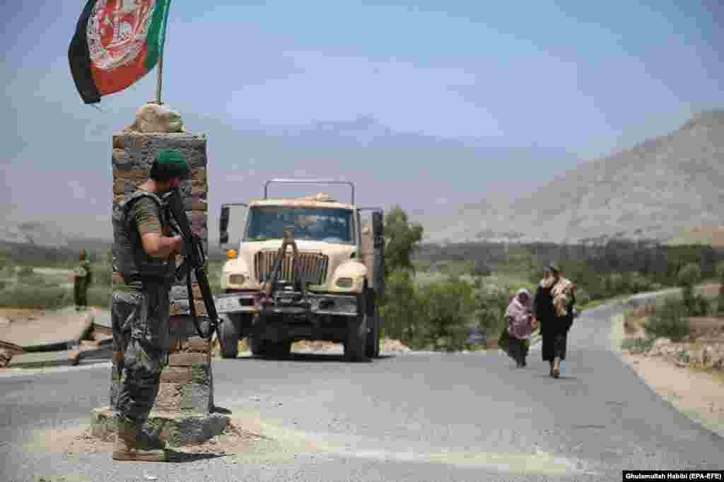 An Afghan soldier watches from a checkpoint in Laghman Province on July 8 after Afghanistan's security forces reportedly cleared the area of Taliban militants.   