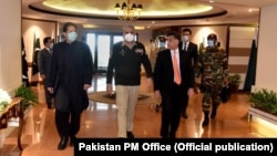 Pakistani Prime Minister Imran Khan visits ISI headquarters in November 2020 accompanied by army chief General Qamar Javed Bajwa (center) and outgoing ISI head Faiz Hameed (right).
