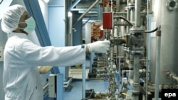 A worker adjusts machinery at a uranium-conversion plant in Isfahan, Iran.