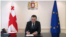 Премьер-министр Грузии Ираклий Гарибашвили подписывает заявление на вступление в ЕС