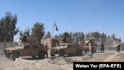 Afghan security forces patrol on the outskirts of Helmand on January 17 amid a surge in Taliban violence across the country.
