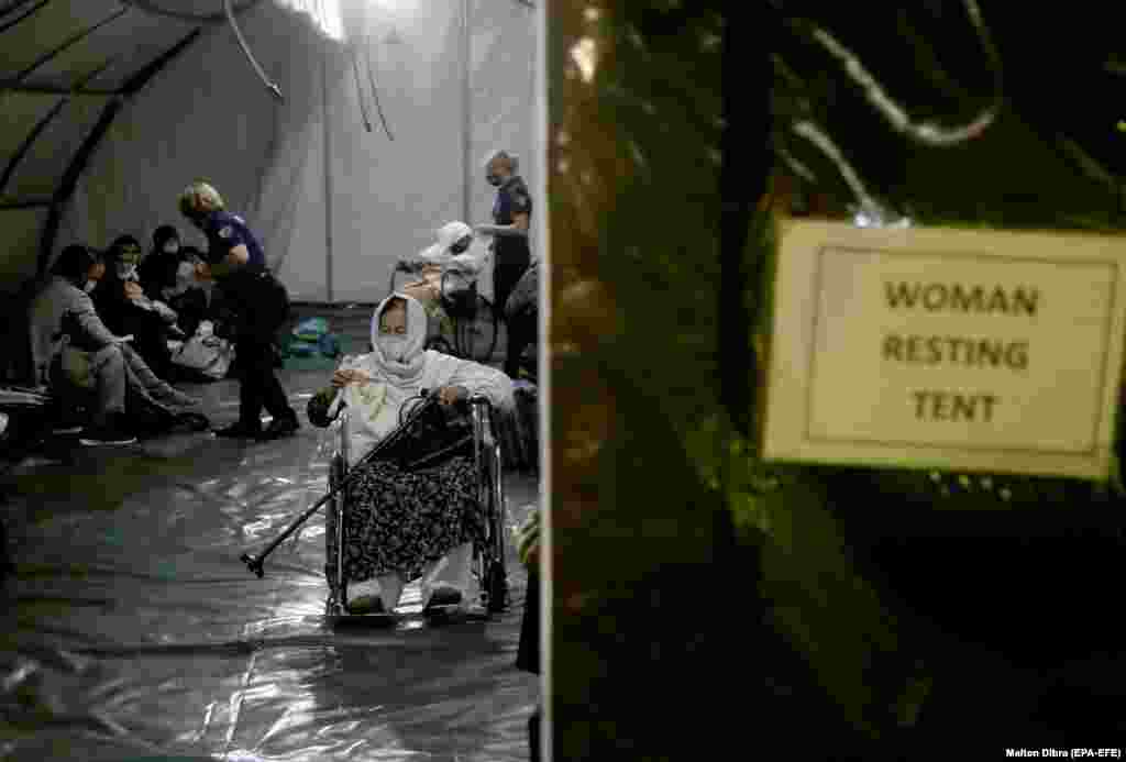 Afghan evacuees inside a tent after landing in Tirana, Albania, on August 27. Albania is expected to shelter 4,000 Afghan citizens who have left their country following the Taliban takeover.