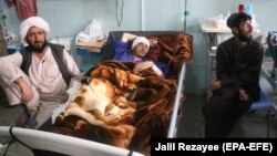Afghan civilians injured in bomb blasts receive medical treatment at a hospital in Herat.