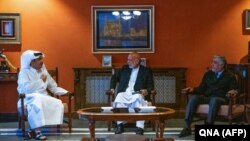 Former Afghan President Hamid Karzai (center) and former head of the Afghan reconciliation council, Abdullah Abdullah (right), meet with Qatari Foreign Minister Sheikh Mohammed bin Abdulrahman Al-Thani (left) on September 12.