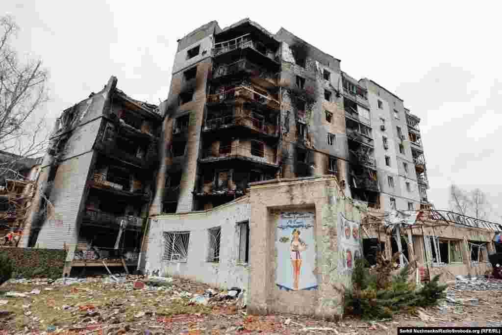 На так званому «колі» стояв будинок №429. Місцеві називали його «У Саші» — за назвою сусіднього ресторану. Російські війська вдарили по ньому і сусідньому будинку вранці 1 березня 2022 року. Це були перші будинки, на які скинули авіабомби. Багатоповерхівки частково завалилися і згоріли.Фото від квітня 2022 року та квітня 2025 року