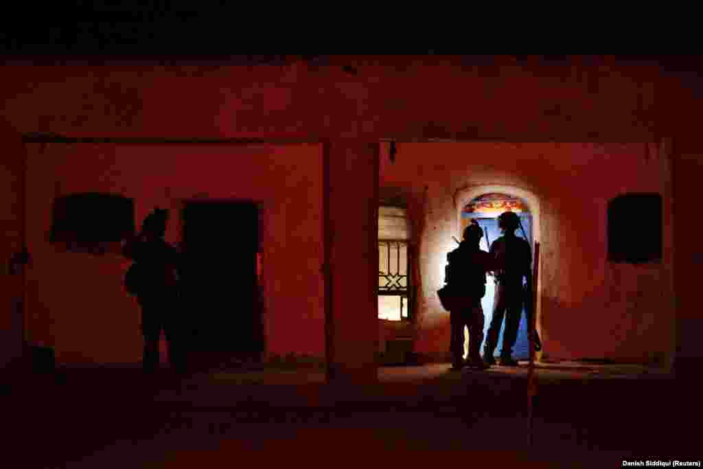 Members of the Afghan special forces search a house during the combat mission against the Taliban. The extremist Islamist group is known for attacking and then melting away, making the fight against the militants extremely difficult in populated areas. 