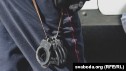 Білоруський міліціонер із наручниками, фото ілюстративне