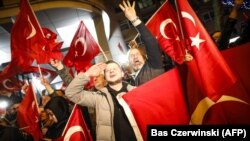 Demonstrators hold Turkish flags as they protested in Rotterdam on March 11 after the Netherlands refused Turkish Foreign Minister Mevlut Cavusoglu permission to land in the country.