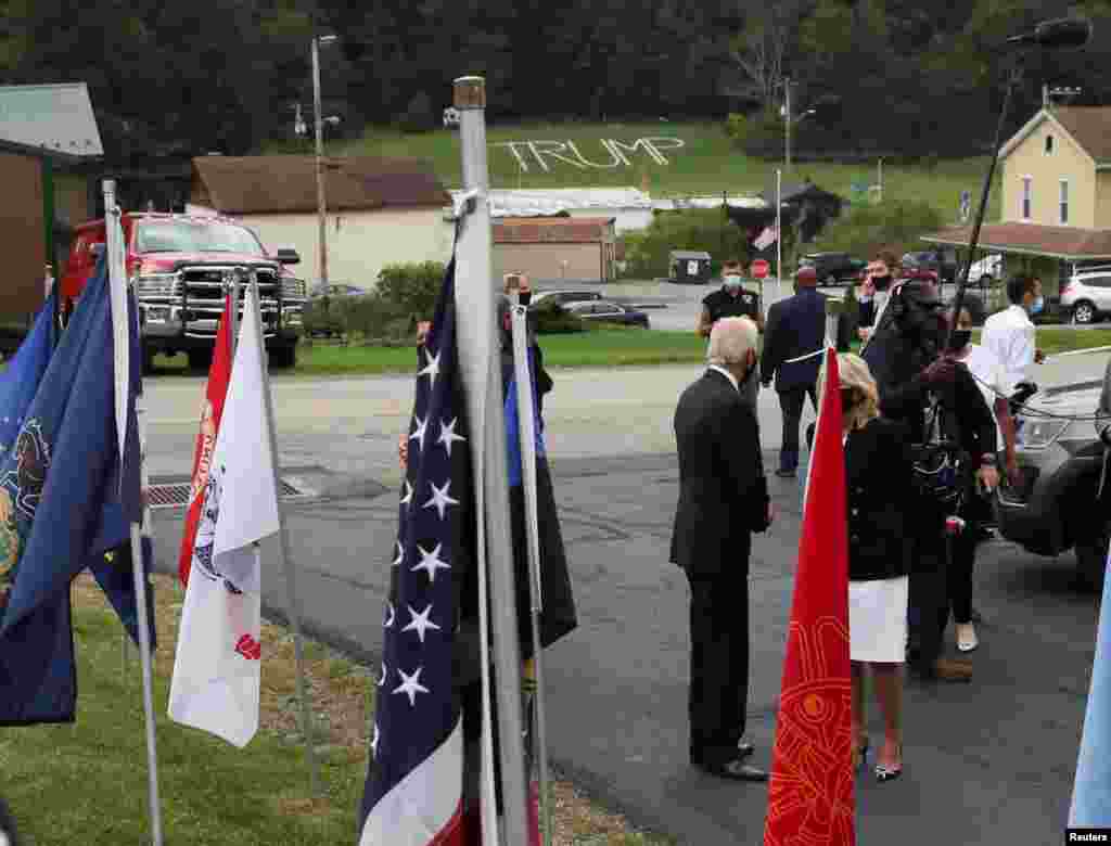 Кандидат у президенти США від Демократичної партії та колишній віцепрезидент Джо Байден дивиться на напис прізвища президента США Дональда Трампа на сусідньому пагорбі, коли Байден і його дружина Джилл прибули відвідати пожежників на пожежній станції Шанксвілл №627 під час відвідування «Національного меморіалу рейсу 93» в Шанксвіллі, штат Пенсильванія, США