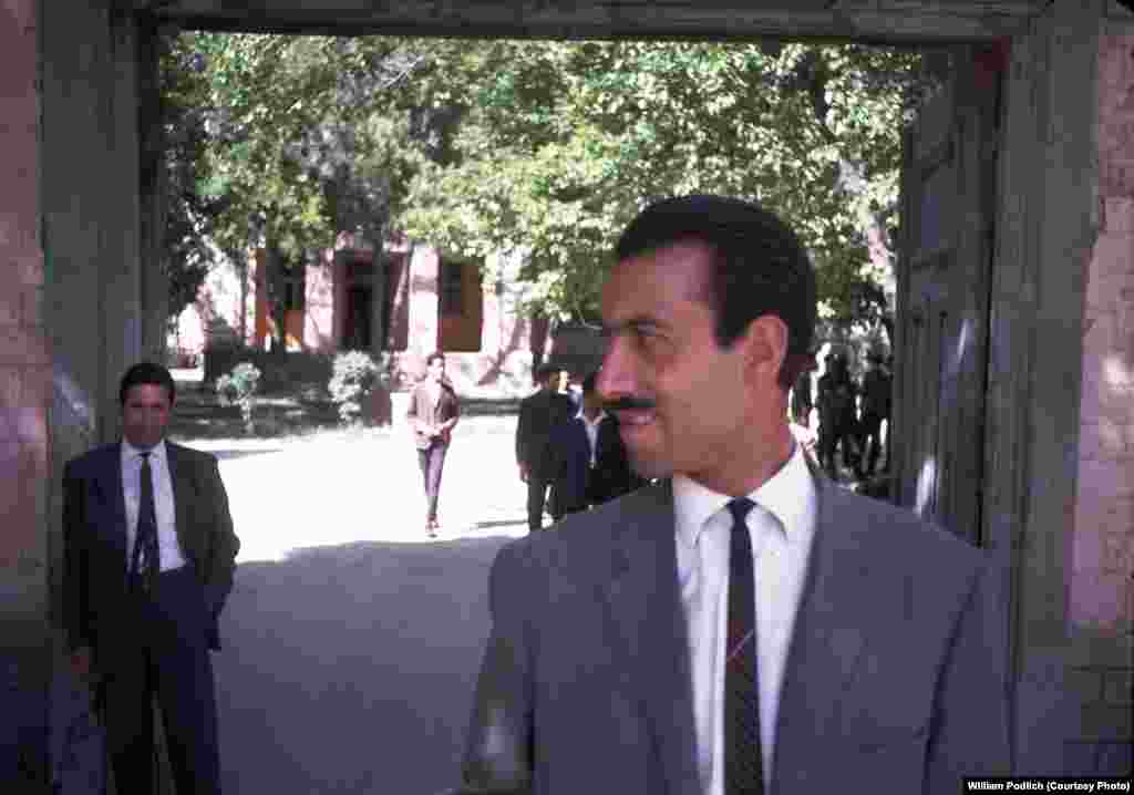 "The Higher Teachers College was a two-year institution for training college-level teachers, located at Seh Aqrab Road and Pul-e Surkh Road, on the west side of Kabul, near Kart-e Sei," recalls Peg Podlich. In this photograph, a Mr. Bahir (left), who was William Podlich's counterpart at the college, and an Afghan teacher pose outside the school.